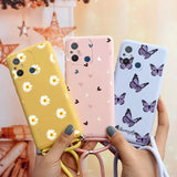 a woman holding two cases with butterflies on them