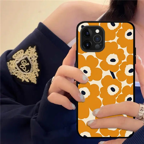 a woman holding a cell phone case