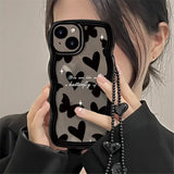 a woman holding a cell phone case with a heart pattern