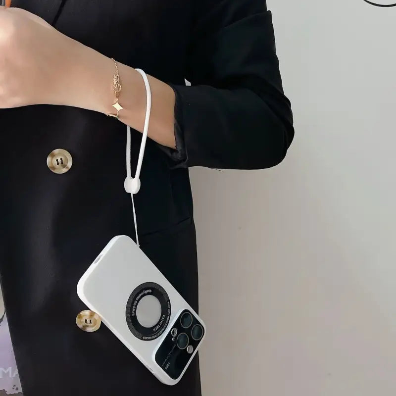 a woman holding a cell phone with a camera attached to it