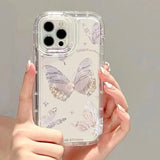 a woman holding a clear case with butterflies on it