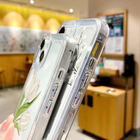 a woman holding a clear case with a flower design on it