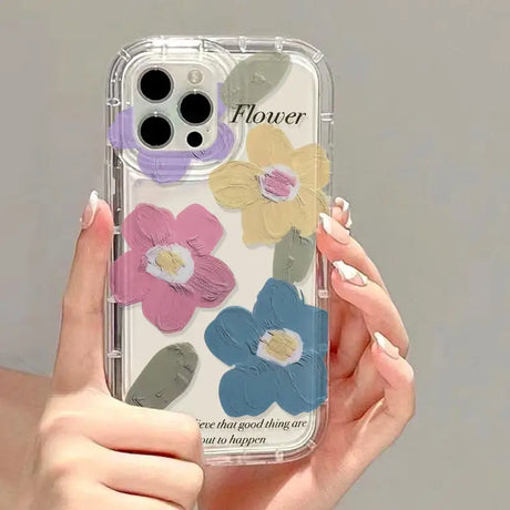 a woman holding a phone case with flowers on it