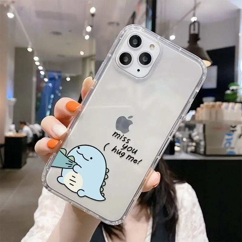 a woman holding up a clear case with a cartoon character on it
