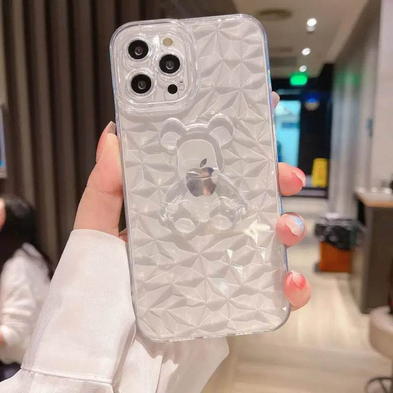 a woman holding a clear case with a white flower design