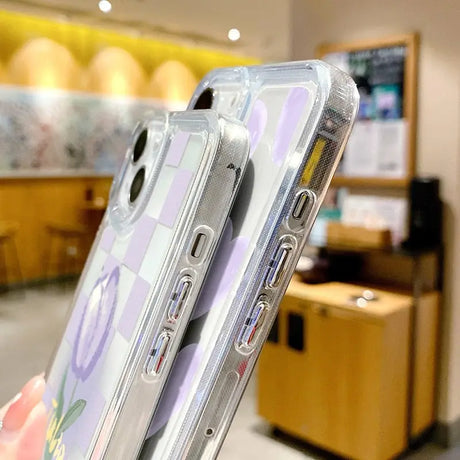 a woman holding a clear case with a flower pattern on it