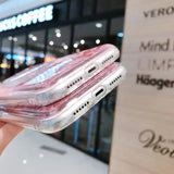 a woman holding a clear case with a pink liquid inside