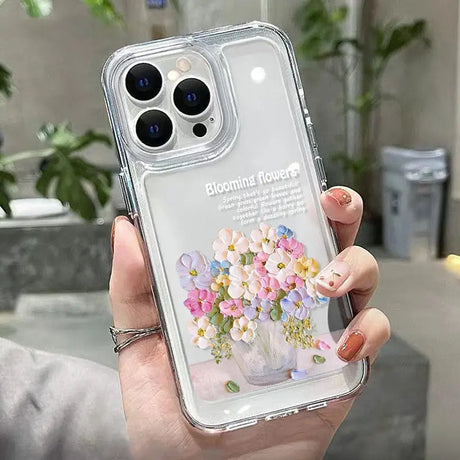 a woman holding a clear phone case with flowers