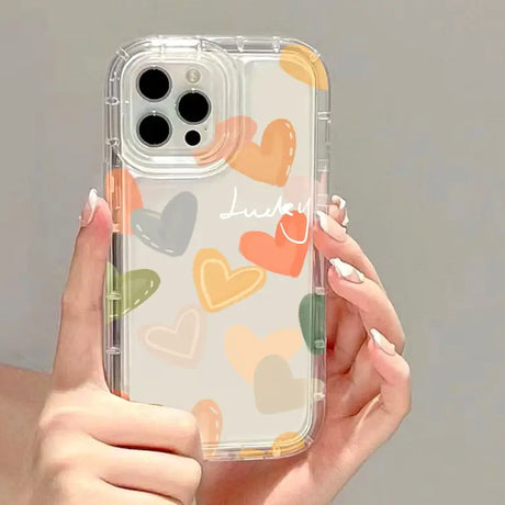 a woman holding a phone case with hearts on it