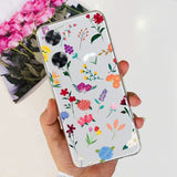 a woman holding a phone case with flowers on it