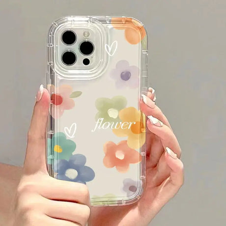 a woman holding a clear phone case with colorful flowers