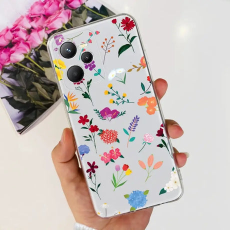 a woman holding a phone case with flowers on it