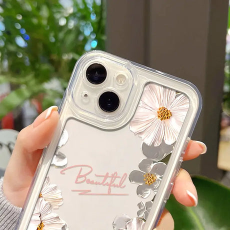 a woman holding a clear phone case with flowers on it