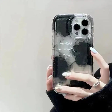 a woman holding a phone case with a heart design