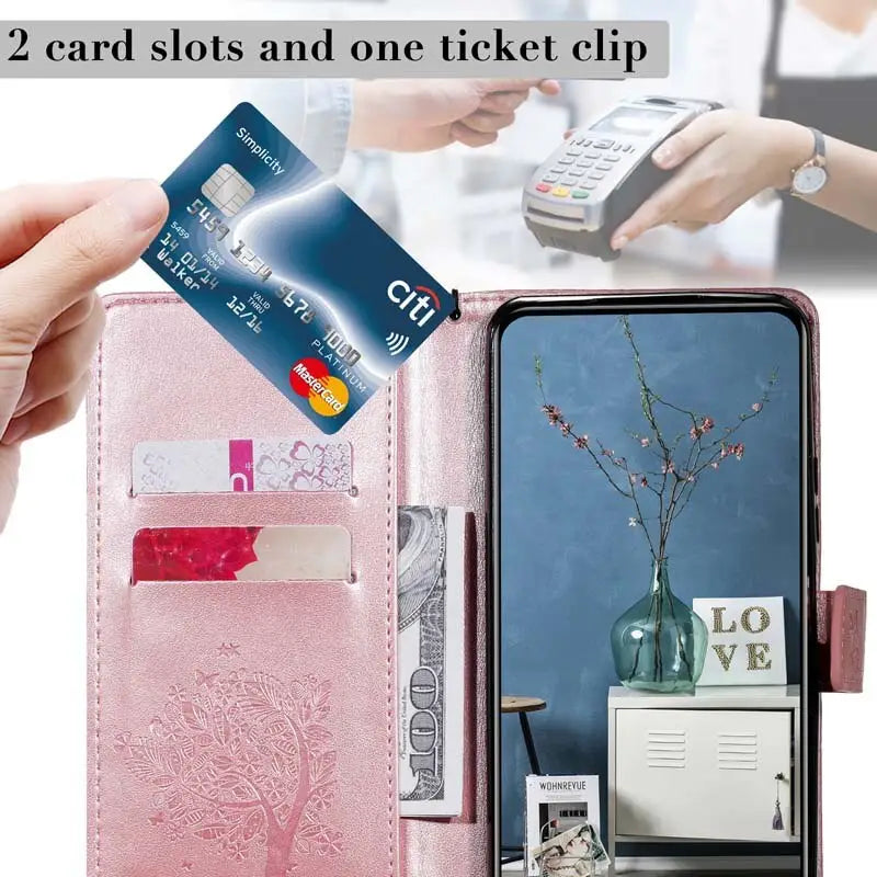 a woman holding a credit card and a pink wallet case