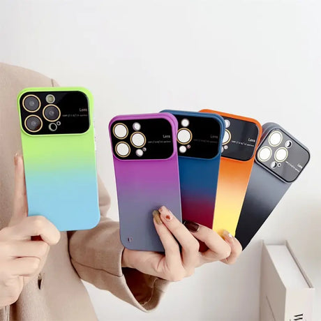 a woman holding four iphone cases in her hands