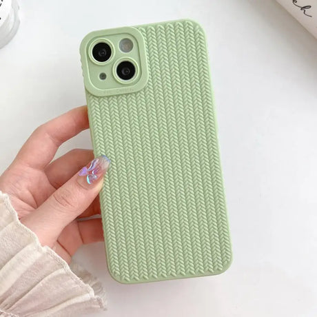 a woman holding a green iphone case