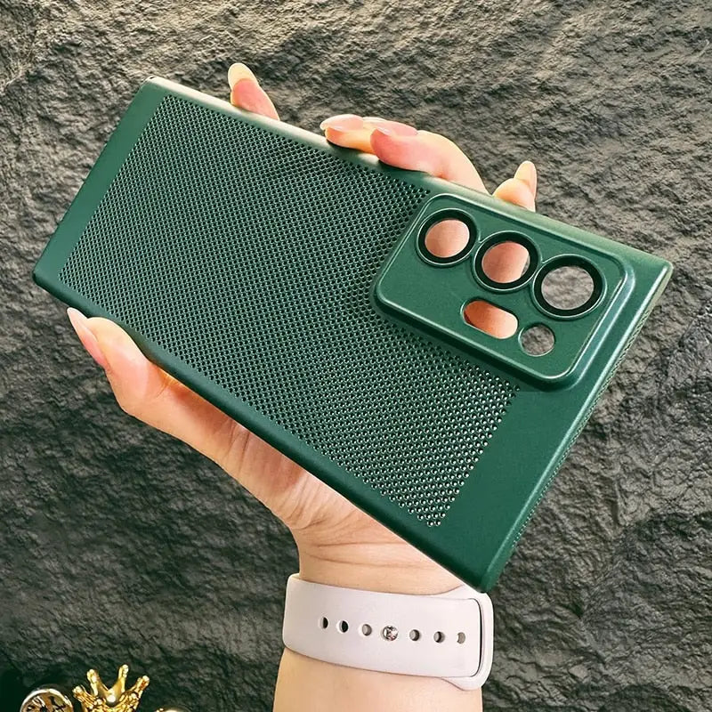 the green phone case is held up against a rock