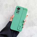 the back of a green iphone case with a hand holding it