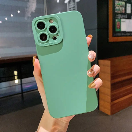 a woman holding a green iphone case