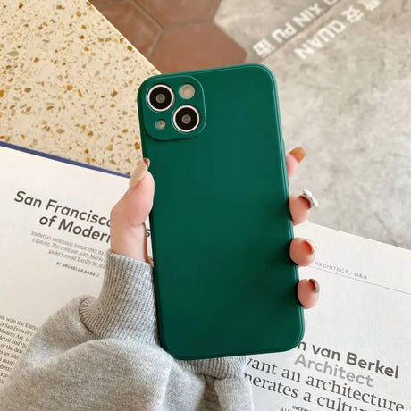 a woman holding a green iphone case