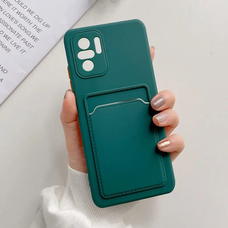 a woman holding a green leather case with a phone in her hand