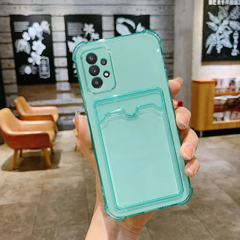 a woman holding a green phone case