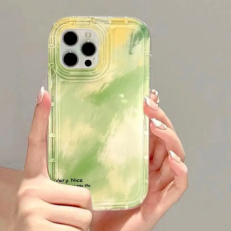 a woman holding a green phone case