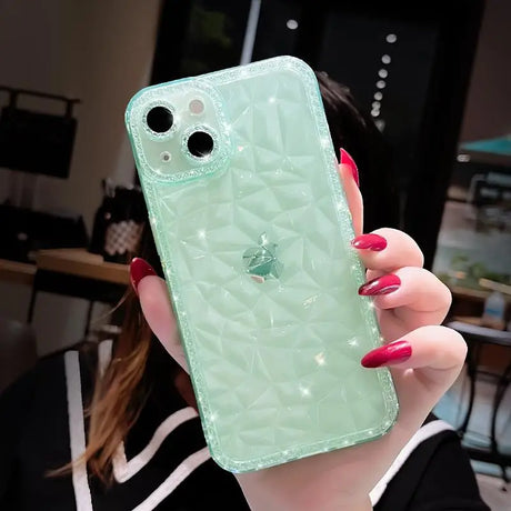 a woman holding a green phone case