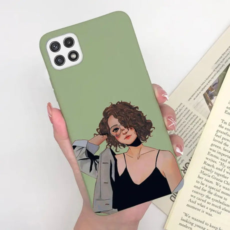 a woman holding a book and a phone case