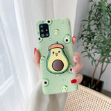 a woman holding a green phone case with a cartoon character on it