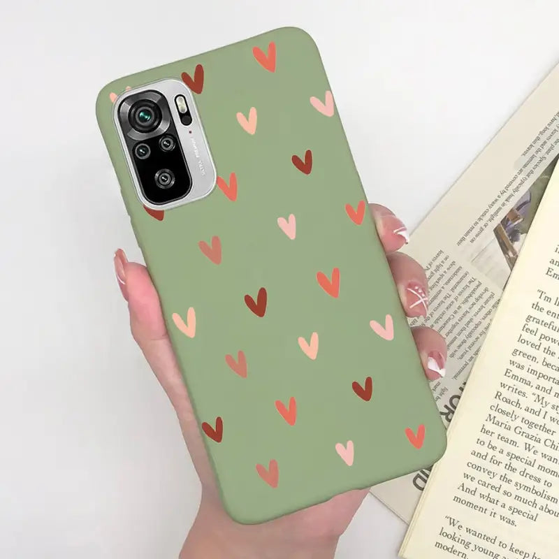 a woman holding a book and a phone case