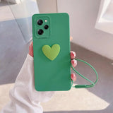 a woman holding a green phone case with a heart on it