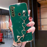a close up of a person holding a green phone case with a heart and keychain