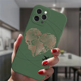 a woman holding a green phone case with a gold map on it