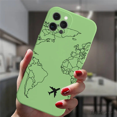 a woman holding a green phone case with a world map on it