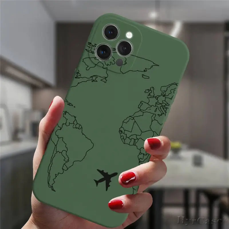 a woman holding a green phone case with a world map on it