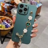 a woman holding a green phone case with a chain