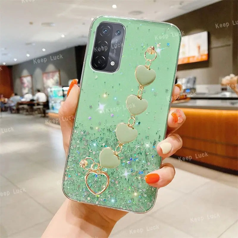 a green phone case with a heart and a heart shaped ring