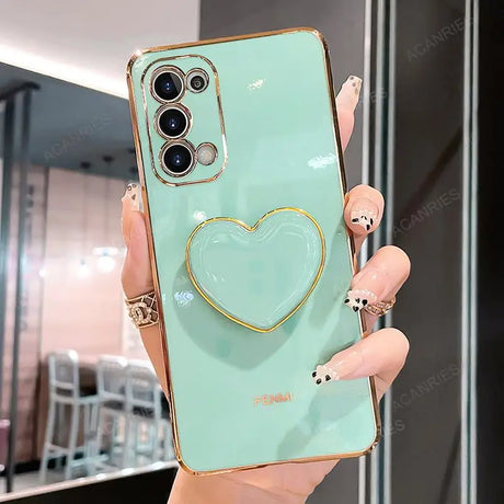 a woman holding a green phone case with a heart