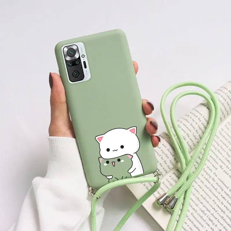 a woman holding a green phone case with a cat on it