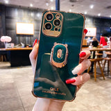 a woman holding up a green phone case