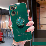 a close up of a person holding a green phone case with a diamond ring