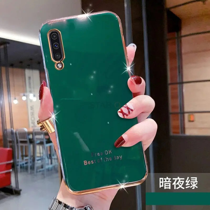 a woman holding a green phone case