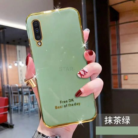 a woman holding a green phone case with a gold ring