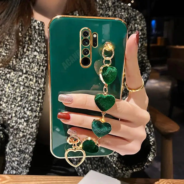 a woman holding a green phone case with a gold ring