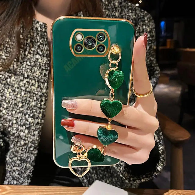 a woman holding a green phone case with a gold ring