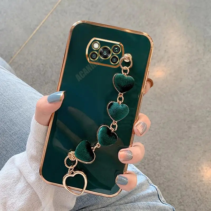a woman holding a green phone case with a heart shaped phone holder