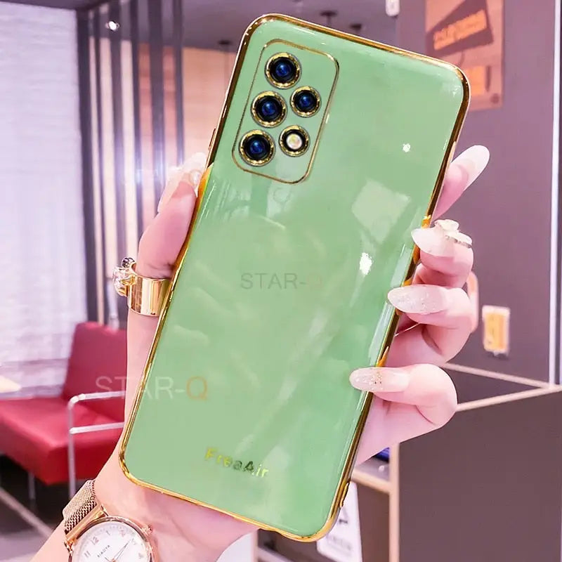 a woman holding up a green phone case