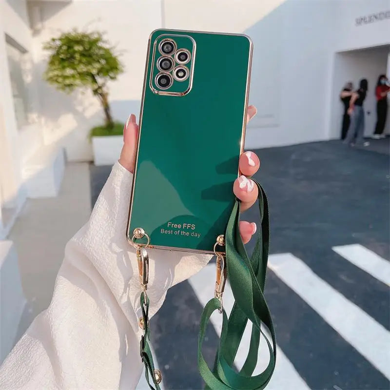 a woman holding a green phone case with a camera attached to it